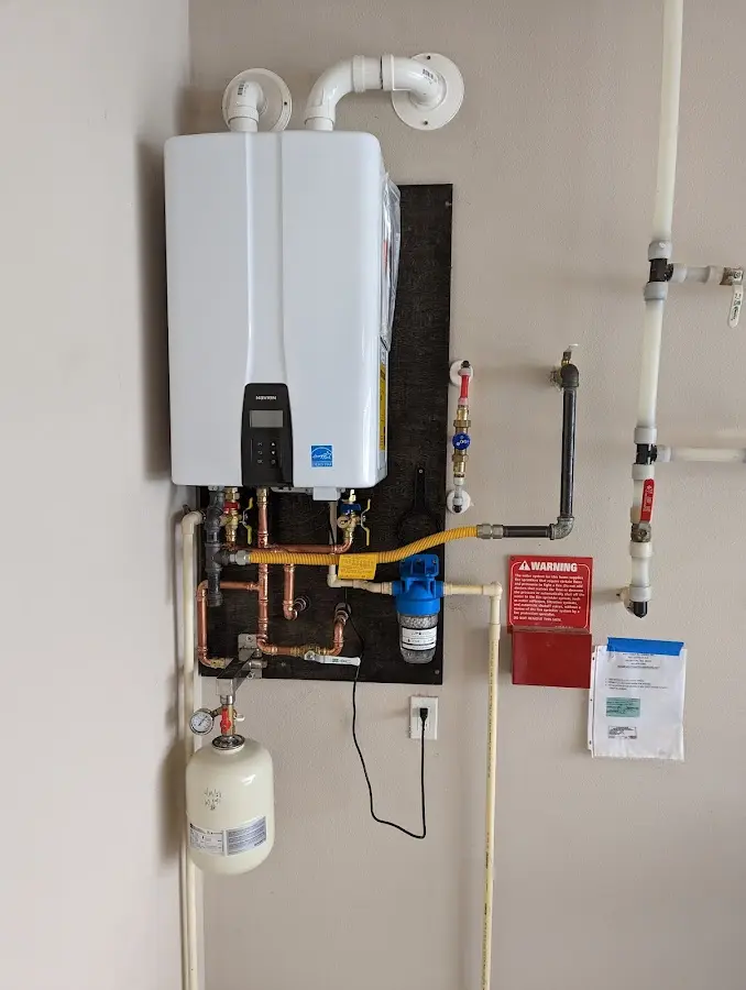 Professional plumber installing copper piping in a Provincetown home